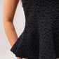 Iris Textured Peplum Top In Black
