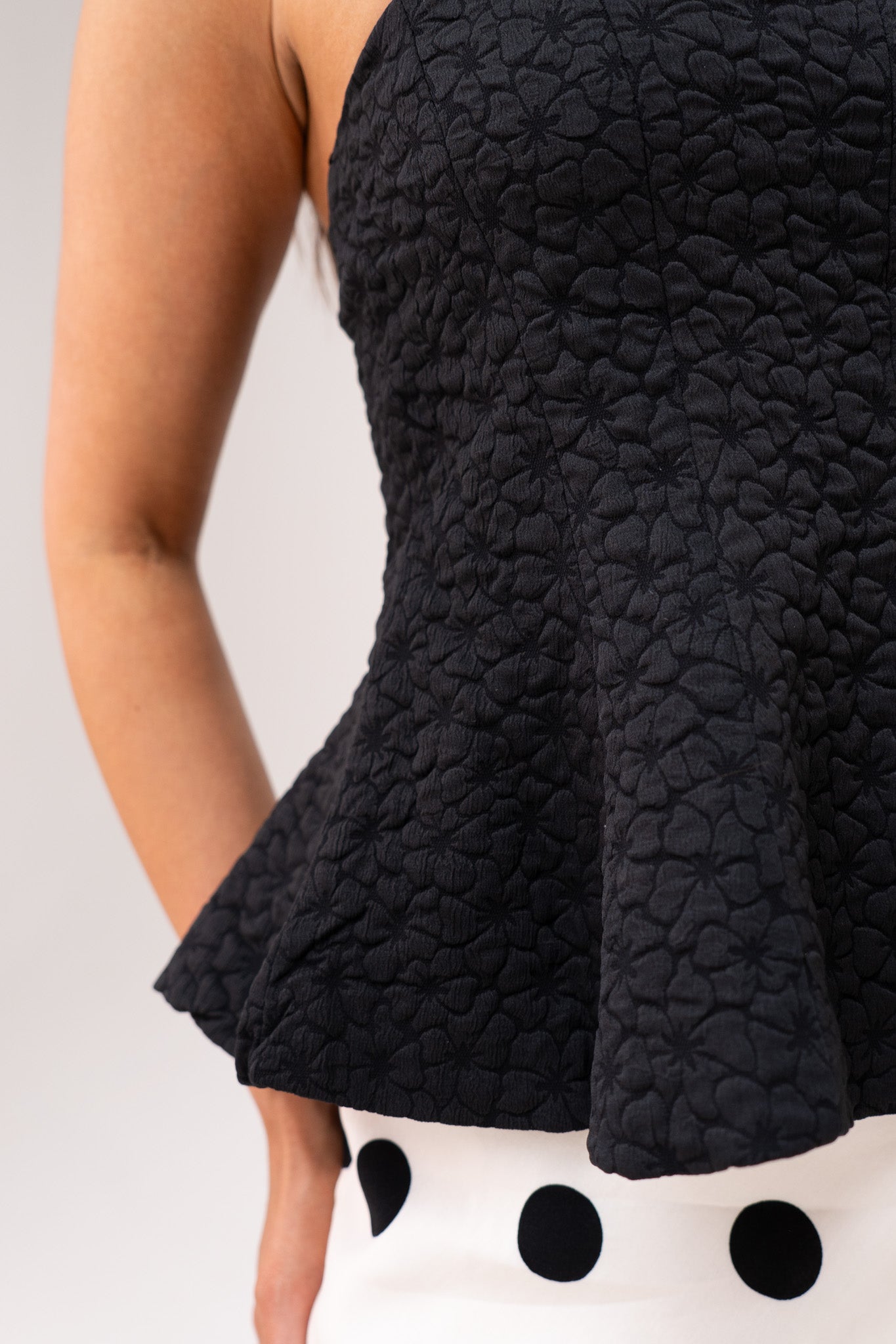 Iris Textured Peplum Top In Black